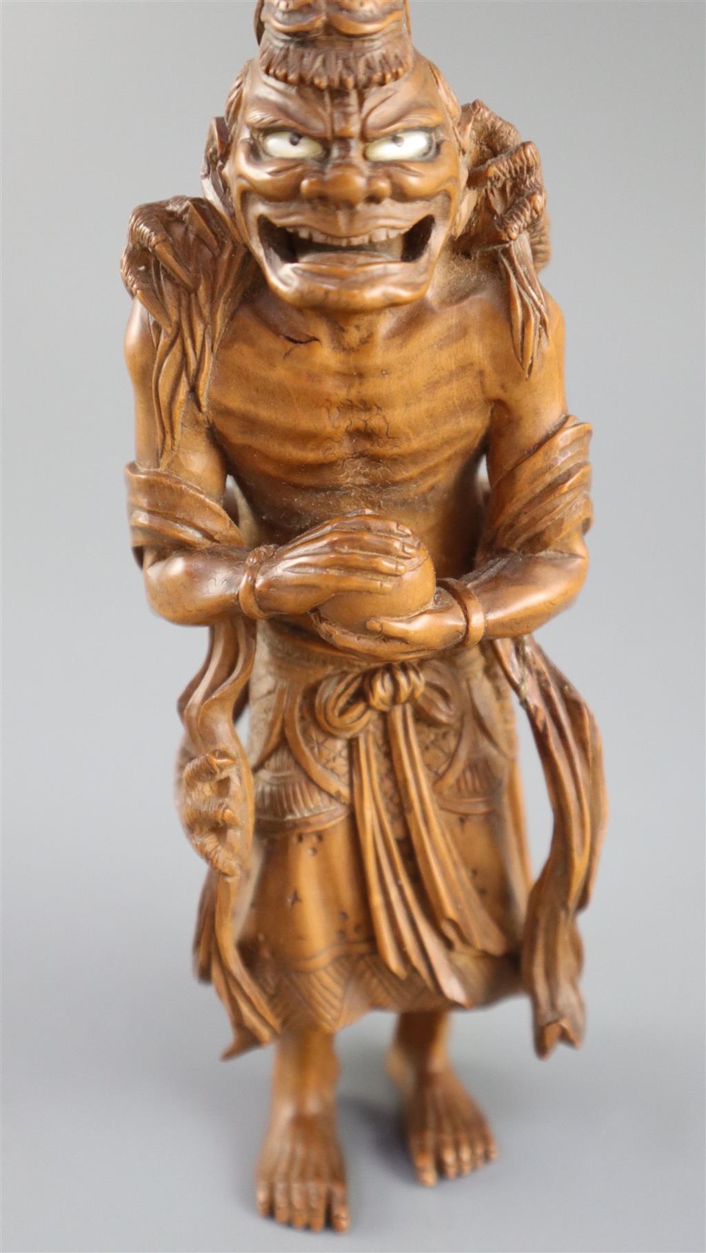 A fine Japanese boxwood okimono of the Sennin Handaka Sonja with a dragon clambering on his back, 19th century, signed Masakazu, 16.5cm